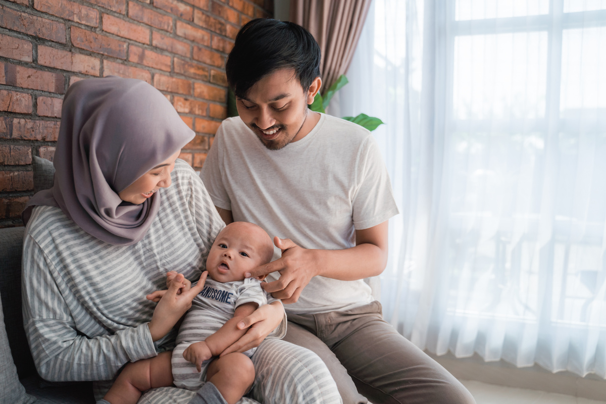 Muslim Parent with Their Newborn Baby at the Livingroom